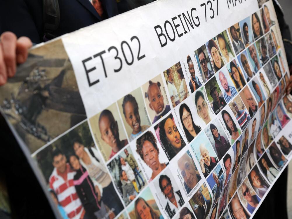 Relatives of victims hold a placard with photos of victims of the Ethiopian Airlines Flight 302 crash in March 2019, prior to a hearing in Fort Worth, Texas, in January 2023.