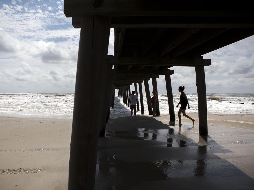 People walk along the beach in Margate, N.J., on Sept. 4, 2016. In 1999, bones that have now been determined to be the remains of ship captain Henry Goodsell were found washed ashore in Margate.