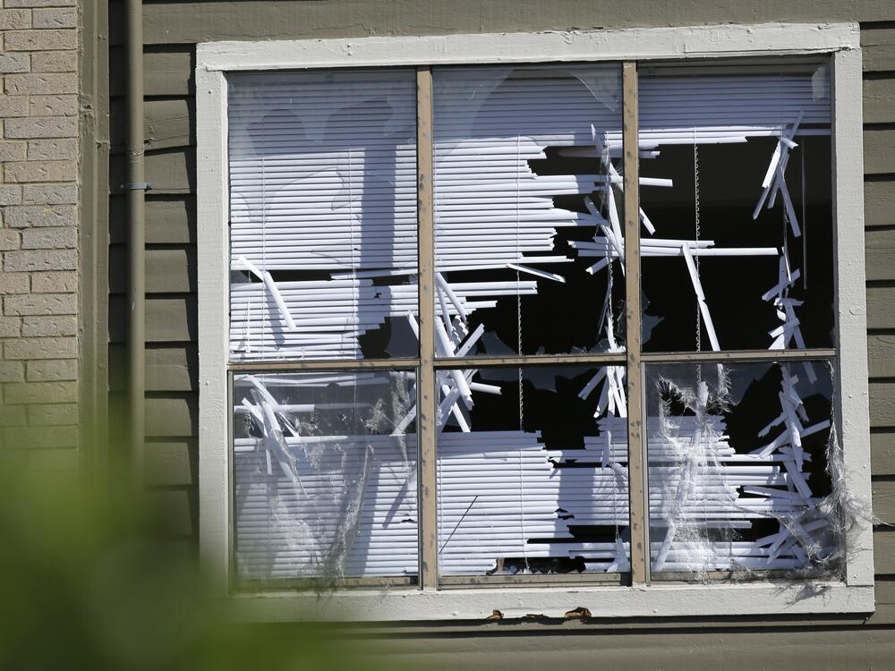 Blinds are shredded in windows broken by a hail storm in Plano, Texas, in 2016.
