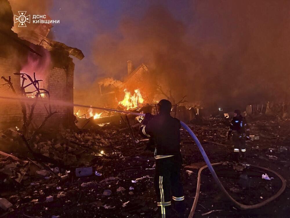 In this photo provided by the Ukrainian Emergency Service, firefighters try to put out a fire following a Russian attack in Kyiv region, Ukraine, Sunday, May 25, 2025.