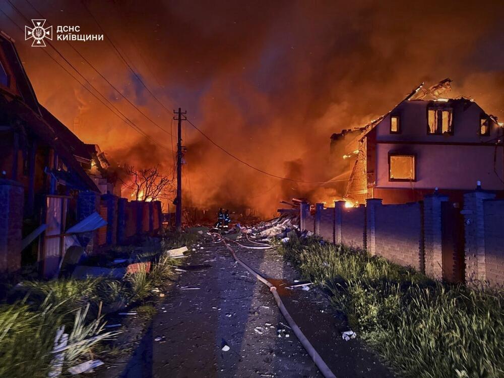 In this photo provided by the Ukrainian Emergency Service, firefighters try to put out a fire following a Russian attack in Kyiv region, Ukraine, Sunday, May 25, 2025.