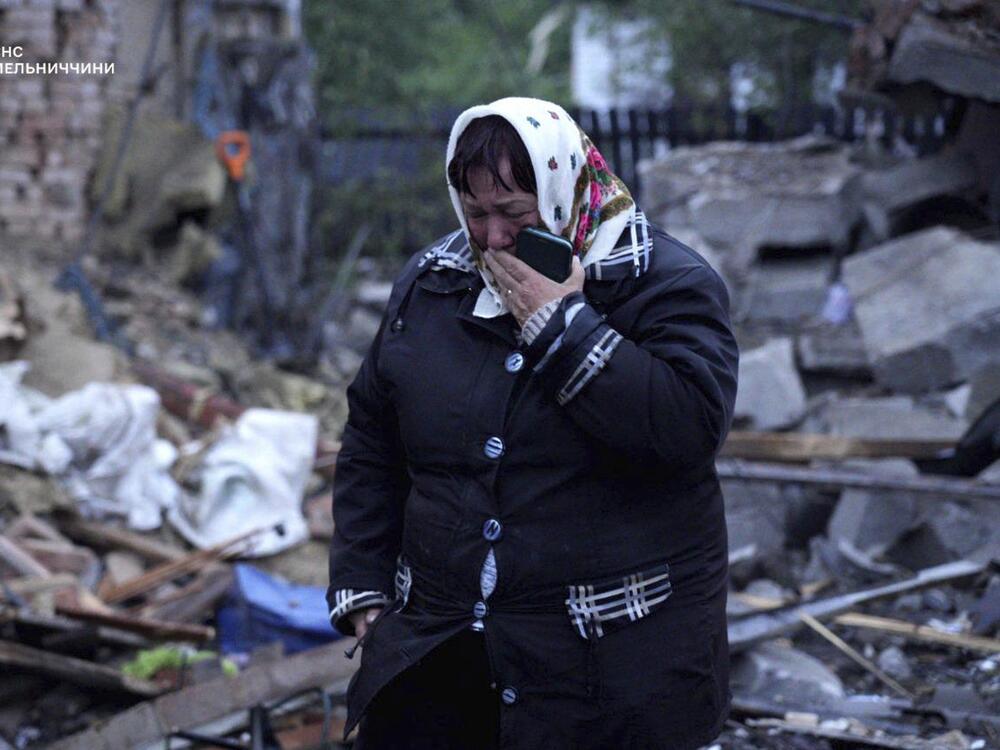In this photo provided by the Ukrainian Emergency Service, a local resident cries standing amid the rubble of her house ruined after Russia's air attack in Khmelnytskyi region, Ukraine, Sunday, May 25, 2025.
