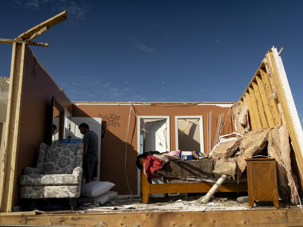 A person walks through a house in the community of Sunshine Hills outside of London, Kentucky. A tornado struck the neighborhood just after midnight on May 17.
