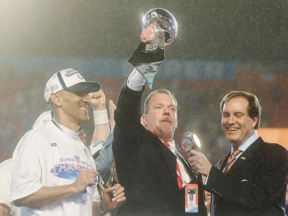 In a now-iconic photo, Jim Irsay hoists the Lombardi Super Bowl trophy in the rain as he celebrates the Colts' win against the Chicago Bears in Super Bowl XLI in February 2007.