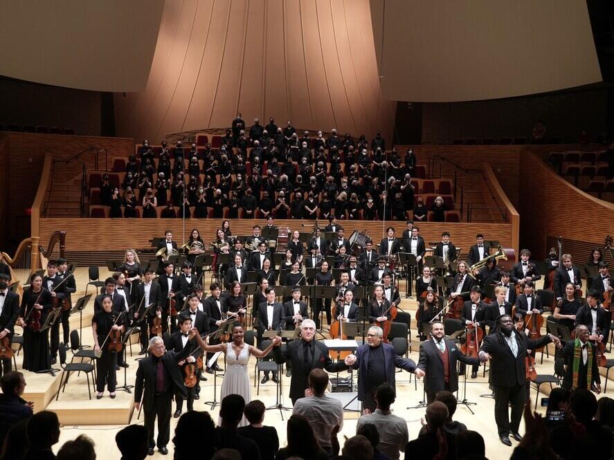 From left: Tenor Alexander Taite, baritone Wilford Kelly, mezzo-soprano Samantha Rose Williams, conductor Paul Phillips, composer Adolphus Hailstork and librettist Herbert Martin appear at a 2023 performance with the Stanford Symphony Orchestra and Stanford Symphonic Chorus of <em>A Knee on the Neck</em>, a requiem cantata in honor of George Floyd. The performance marked the West Coast premiere of the piece.
