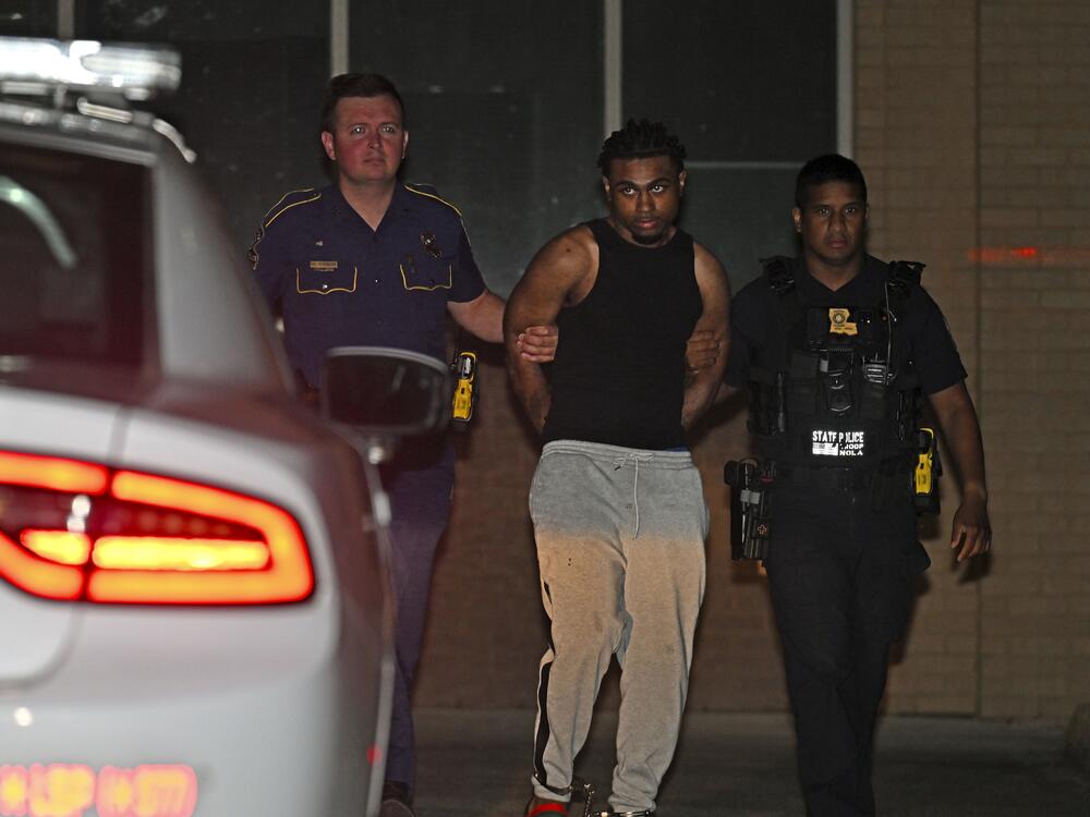 Troopers with Louisiana State Police escort Orleans Parish Prison escapee Lenton Vanburen to a waiting vehicle late Monday, May 26, 2025, at Louisiana State Police Headquarters after he was captured in Baton Rouge, La.