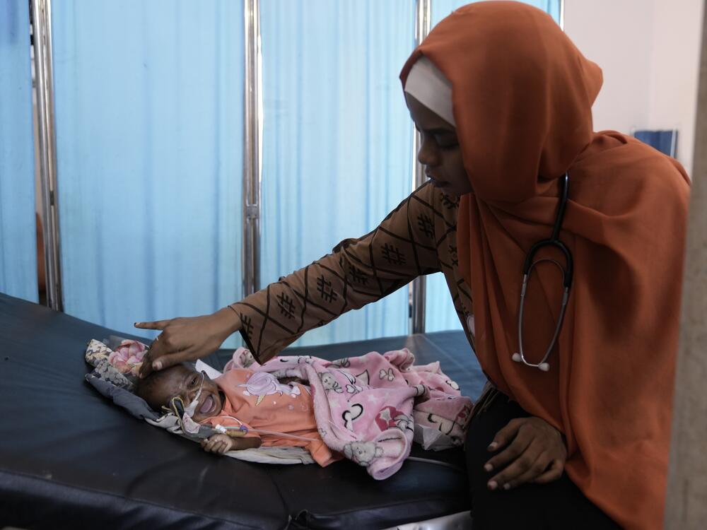 Dr .Sara Abdurahaman at Al-Buluk Pediatric Hospital treats an 8-month old baby in the critical care unit of a malnutrition ward.