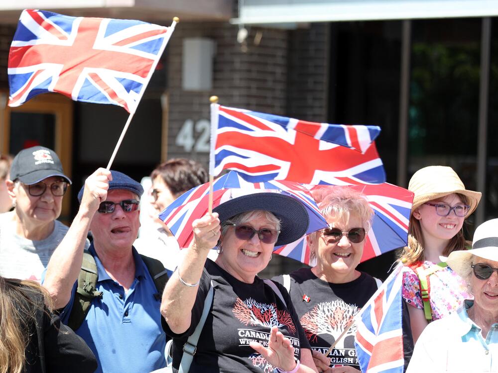 Well wishers wave flags before the arrival of Britain's King Charles III and Queen Camilla at a Lansdowne Park community event in Ottawa, Canada, on Sunday.