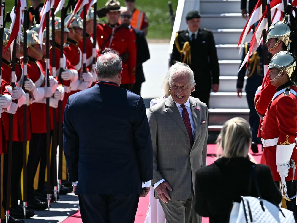 Britain's King Charles III is greeted by an honor guard after arriving at Macdonald-Cartier International Airport in Ottawa, Canada, on Monday.