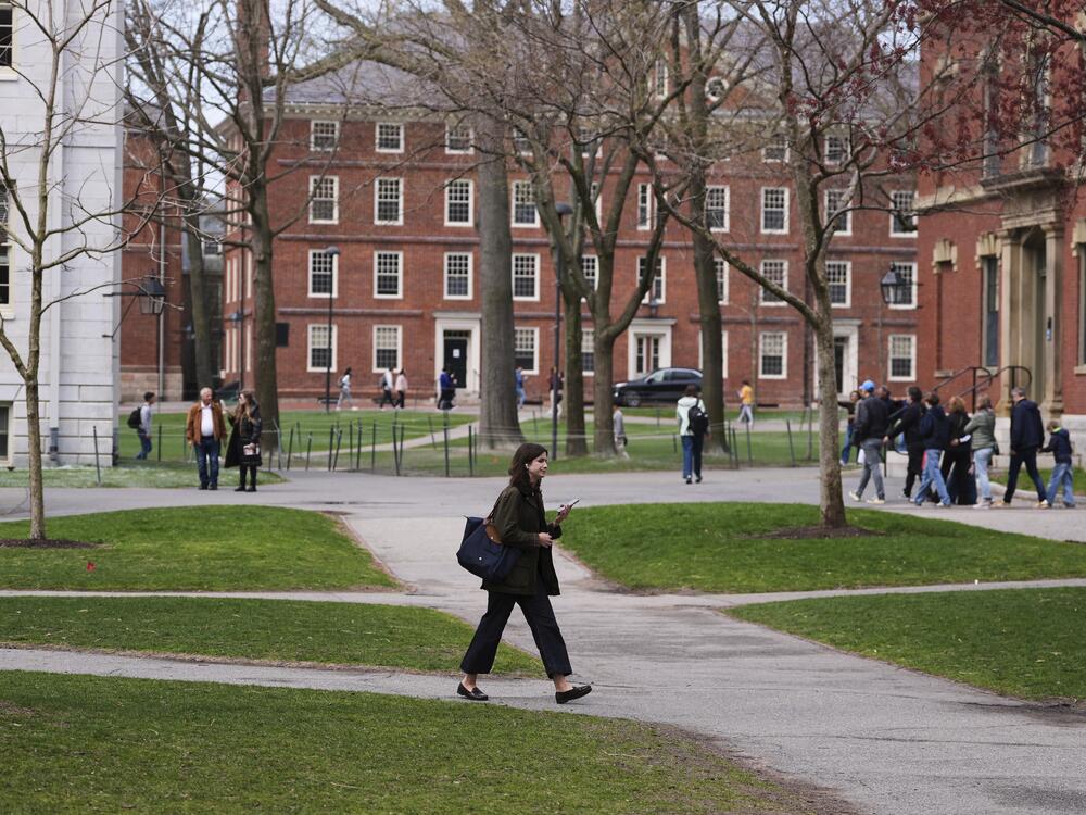 Pedestrians walk through Harvard Yard at Harvard University, Tuesday, April 15, in Cambridge, Mass.