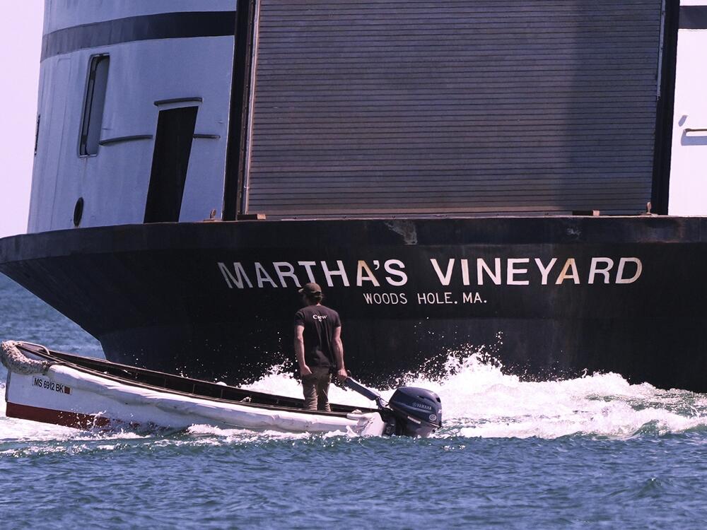 A man navigates the wake behind the Martha's Vineyard Ferry on Monday in Vineyard Haven, Mass.
