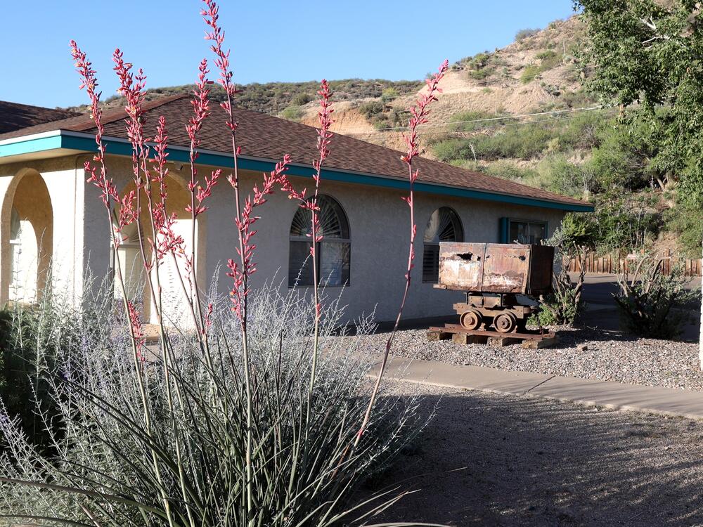 An old mine cart is parked outside the Gila County Historical Museum in Globe, Ariz. Mining is still part of the local economy, but many area residents have low-wage jobs that make them eligible for Medicaid.
