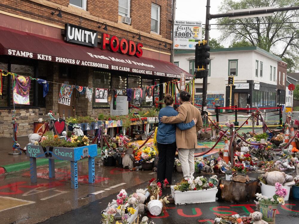 Visitors Taylor Walters and Gerardo Rodriguez Orellana embrace as they take in the memorial space at George Floyd Square, Wed., May 21, 2025, in Minneapolis, Minn.