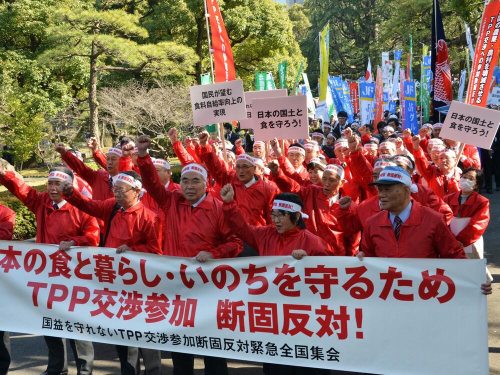 Akira Banzai (center), chief of Japan's farmers association, and their members gesture as they protest against the Trans-Pacific Partnership (TPP) free trade talks at a rally in Tokyo on March 12, 2013, when then-Prime Minister Shinzo Abe was expected to announce he would join TPP negotiations that week.