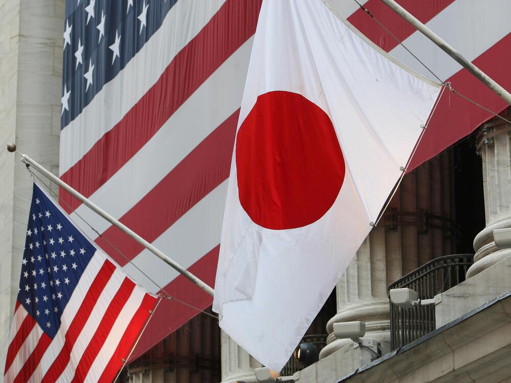 The flag of Japan (right) hangs outside the New York Stock Exchange on May 5, 2008, in honor of Ryozo Kato, the ambassador of Japan to the United States at the time, ringing the opening bell.