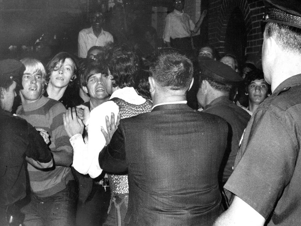 Crowd attempts to impede police arrests outside the Stonewall Inn on Christopher Street in Greenwich Village on June 28, 1969.