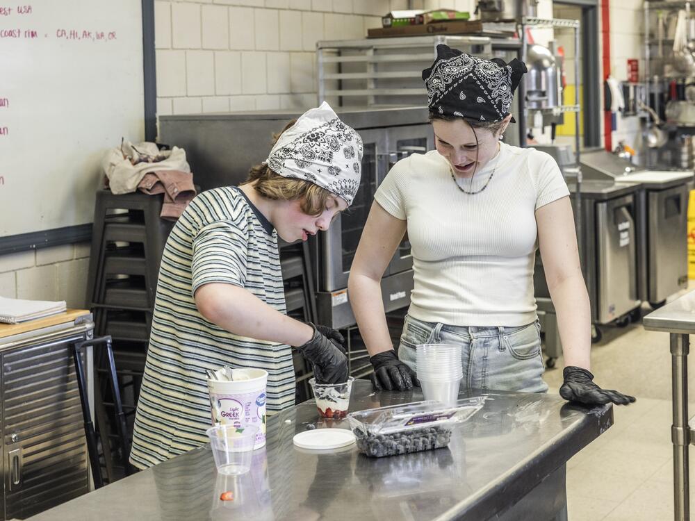 Sixth graders Connor Atkinson and Genevieve Plante work together to make yogurt parfaits in the after-school cooking club in their rural Maine school district.
