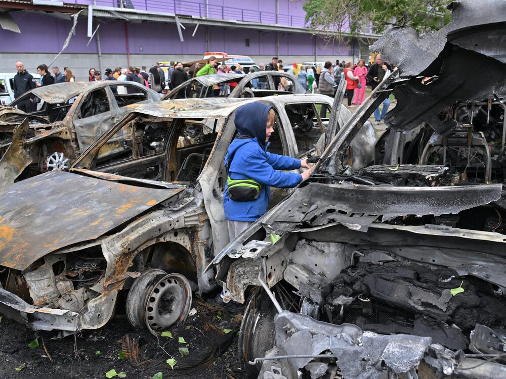 A Ukrainian boy looks at destroyed cars parked outside a mall following Russian drone attacks on Kyiv on May 4. Russia has recently ramped up airstrikes on Ukraine. President Trump has expressed increasing frustration with Russia, but has not taken any action to apply more pressure on Russia.
