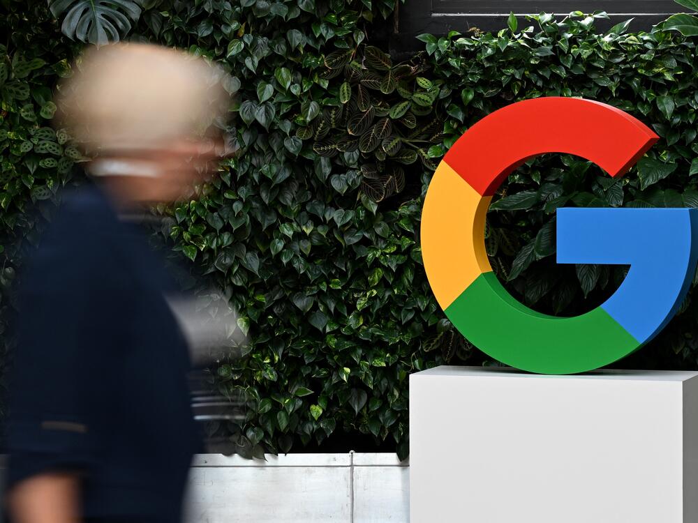 A woman walks past a Google logo at the Google Campus in Warsaw on Feb.13, 2025.