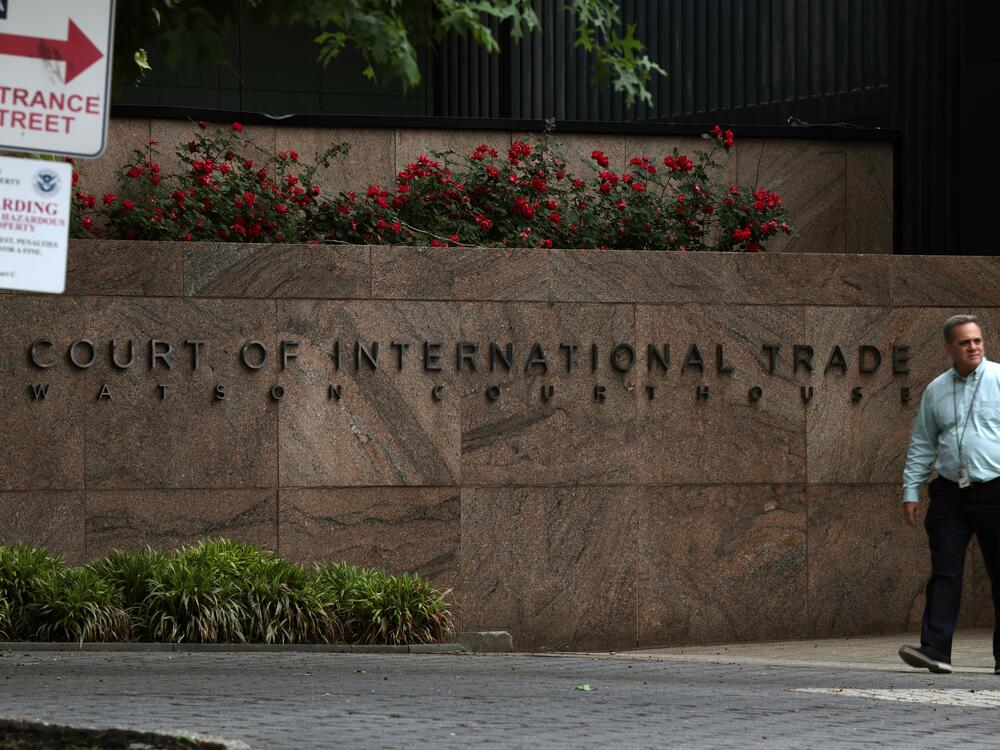 People walk past the U.S. Court of International Trade, Watson Courthouse, in lower Manhattan on Thursday. In a ruling that surprised many, the trade court ruled Wednesday in an opinion by a three-judge panel that a 1977 law called the International Emergency Economic Powers Act does not grant Trump 
