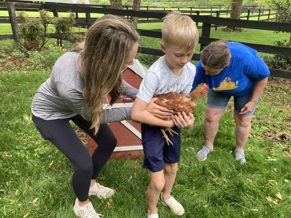 Jack McHonett, 8, and his mother, Jessica McHonett, stand in front of their rental chicken coop at their home in Fairfax, Va.