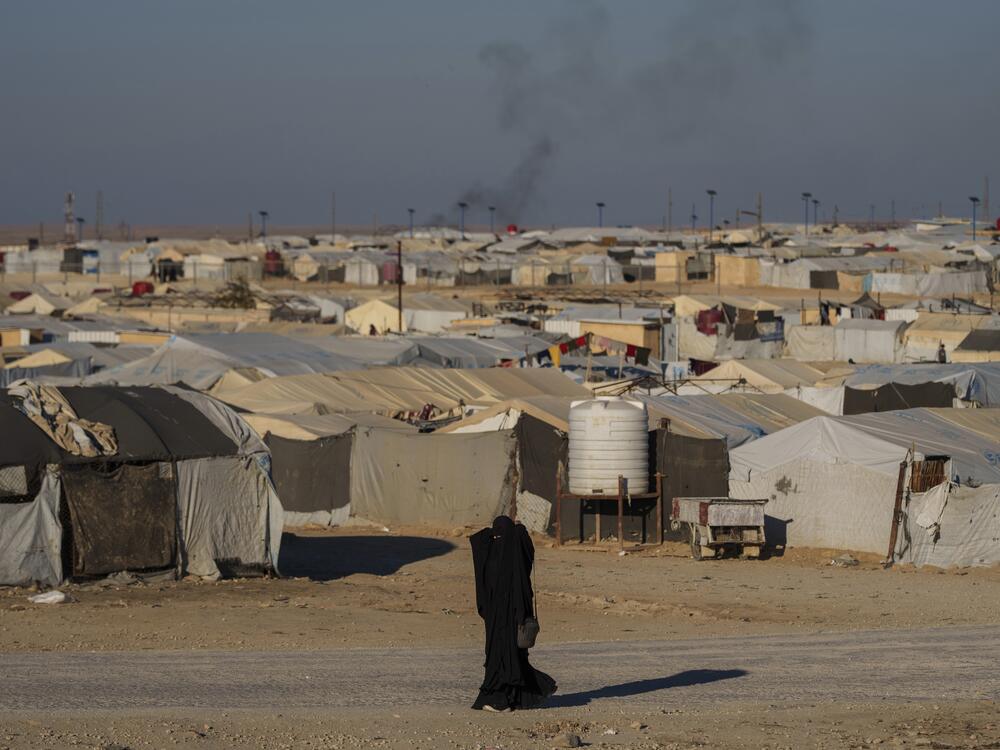 A woman walks in the al-Hol camp in northeastern Syria's Hasakeh province on Jan. 30. Tens of thousands of mostly women and children linked to the Islamic State group have been living here for years.