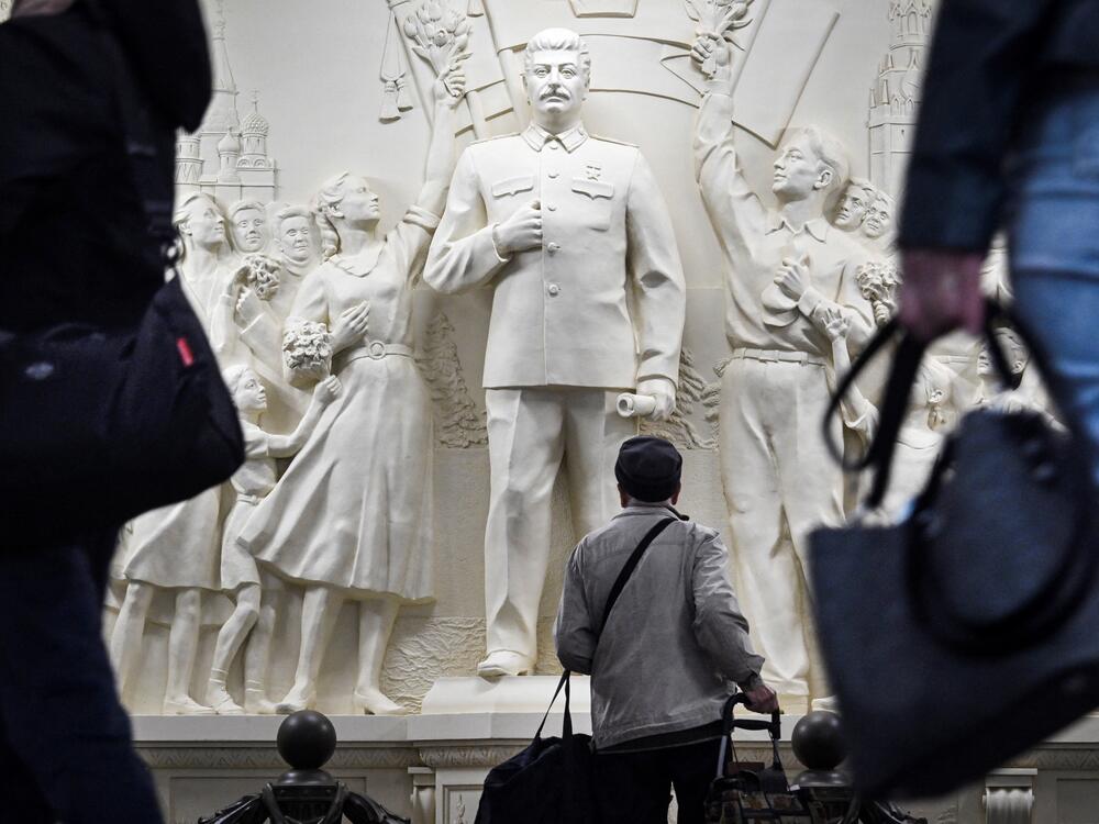 Commuters pause walking past the newly unveiled high relief depicting Soviet dictator Josef Stalin in a passage at Taganskaya metro station in Moscow on May 15, 2025.