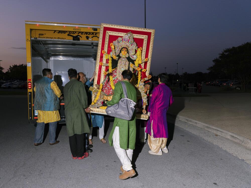 The deity of Durga is carried into a truck at the end of the Northern Virginia Bengali Association's Durga Puja celebration, held at the Freedom High School in Chantilly, Va., on Oct. 12, 2024.