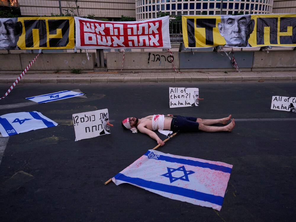 A demonstrator takes part in a performance during a protest demanding the end of the war and immediate release of hostages held by Hamas in the Gaza Strip, and against Prime Minister Benjamin Netanyahu's government in Tel Aviv, Saturday, May 31, 2025.