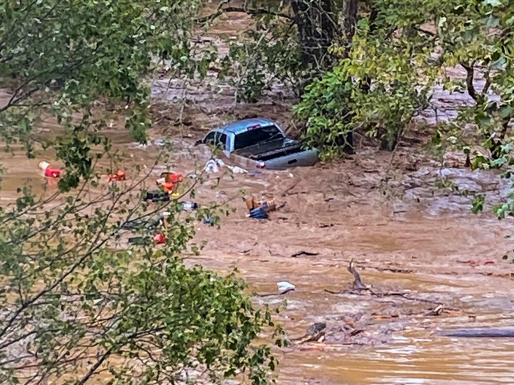 Sarah Bivins and Barry Cooper's truck being washed downstream from their farm during the flooding from Hurricane Helene.