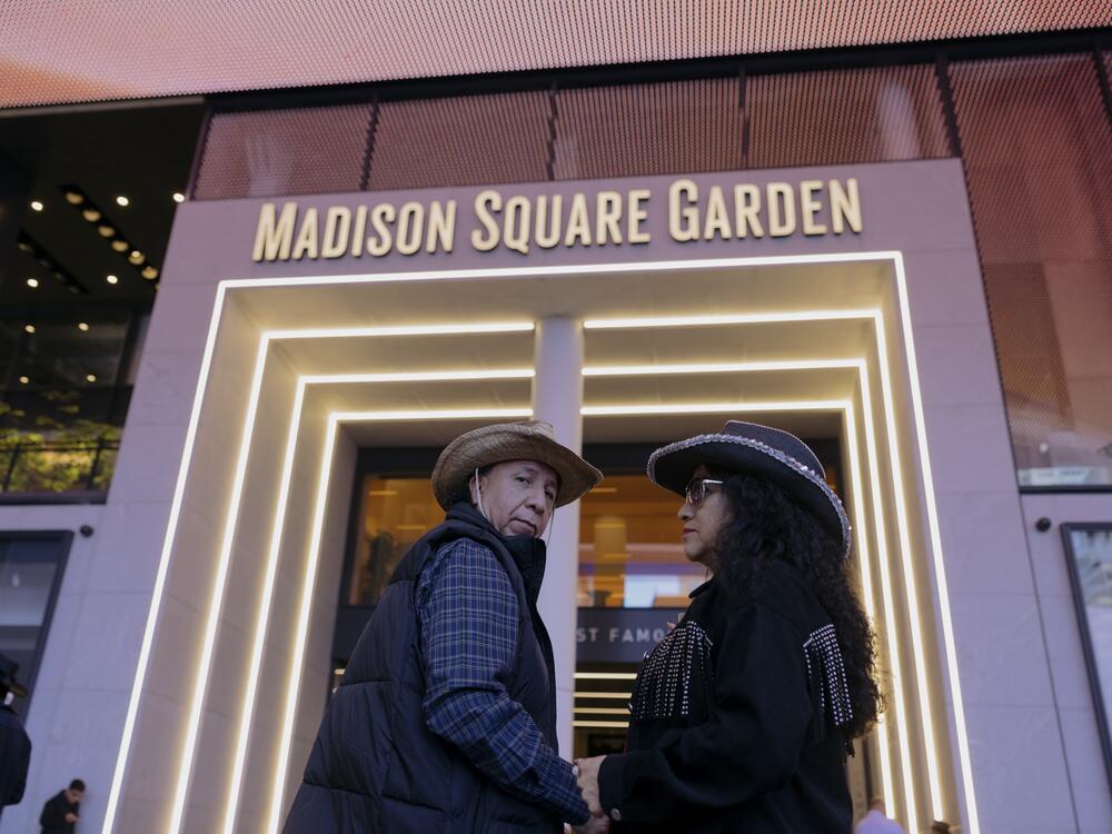 A couple dons their cowboy hats as they make their way into Madison Square Garden for an evening of music from the norteño band Los Tigres del Norte.