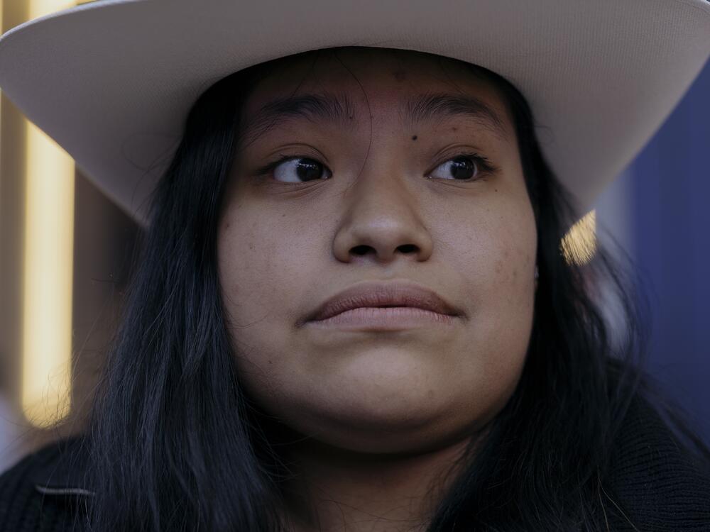 Joselyn Romero dons a white hat.