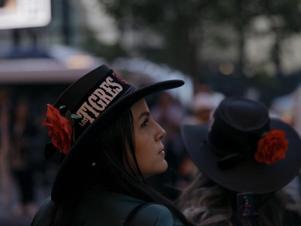 Los Tigres del Norte's fans navigate the bustling block outside of Madison Square Garden before the start of the band's show on Saturday, May 24.