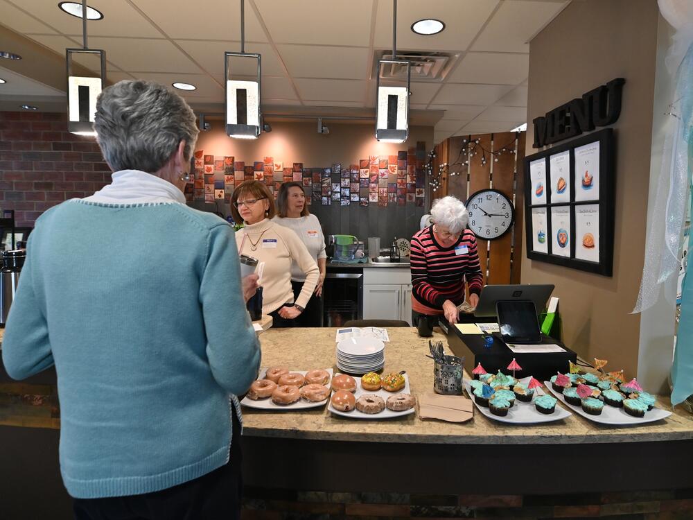 As things get underway at the memory cafe in Clarks Summit, Penn., guests help themselves to breakfast pastries.