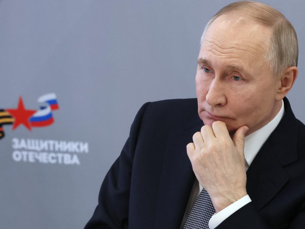In a photograph distributed by the Russian state agency Sputnik, Russia's President Vladimir Putin meets in Moscow on March 6, 2025, with workers and wards of the Defenders of the Fatherland State Fund, the foundation supporting veterans of the Russian invasion of Ukraine.