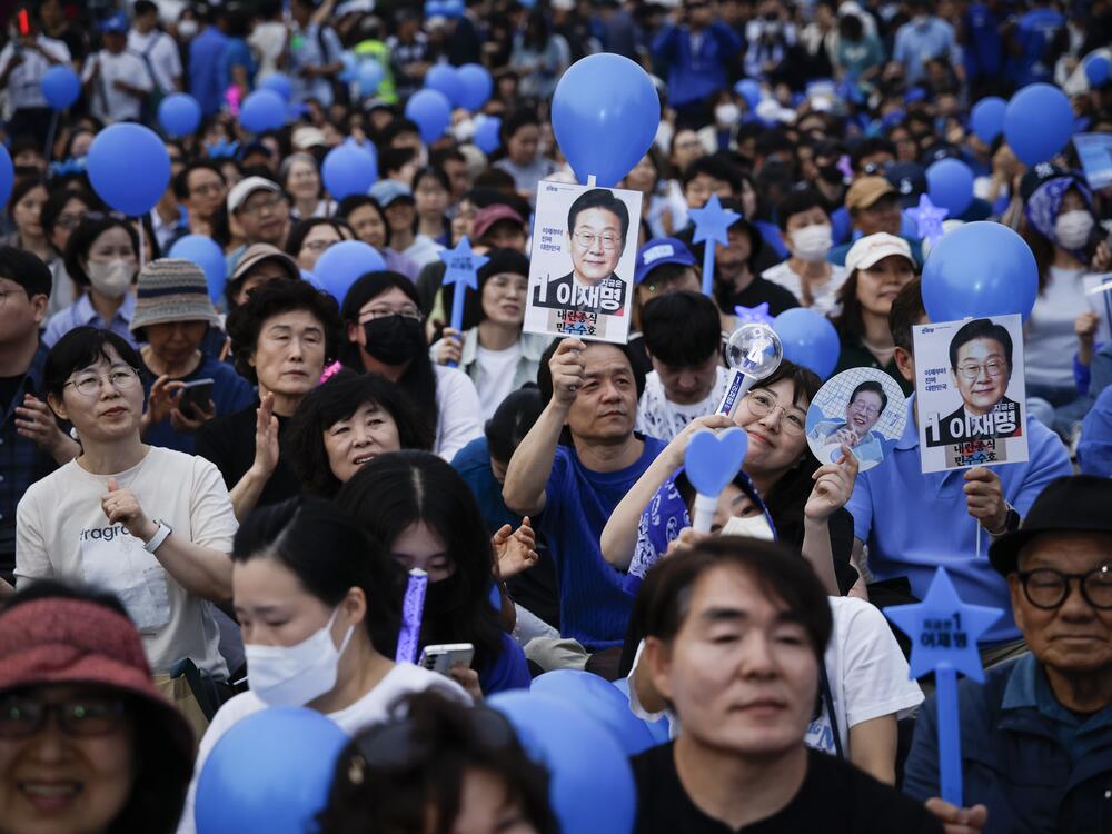 Supporters of South Korean presidential candidate Lee Jae-myung of the Democratic Party wait for him to come for a campaign rally on Monday in Seoul, South Korea.