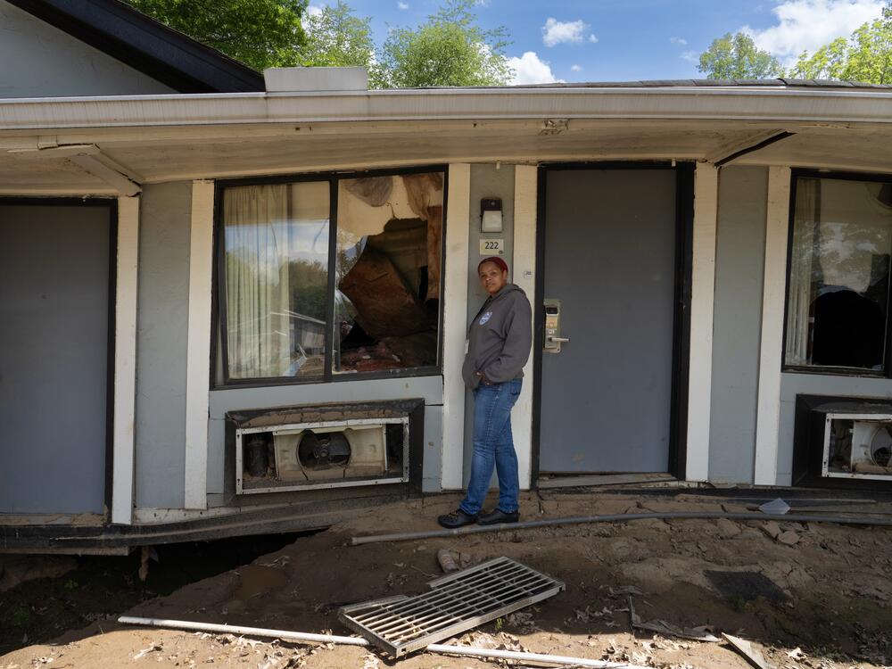 Kim Maisch stands in front of the room at the Super 8 Motel where her father was living in September 2024.  Flooding from the remnants of Hurricane Helene shifted many of the buildings in the motel complex completely off their foundations.