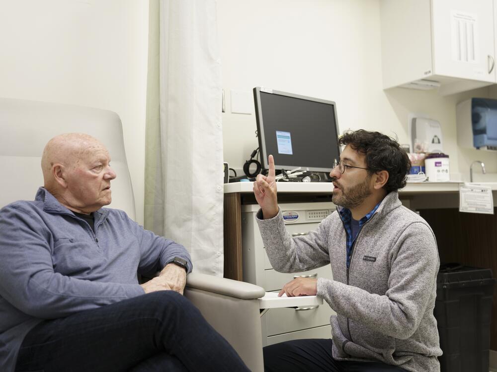 Dr. Brahyan Galindo-Mendez, right, administers an eye-tracking test to Walsh after his treatment.