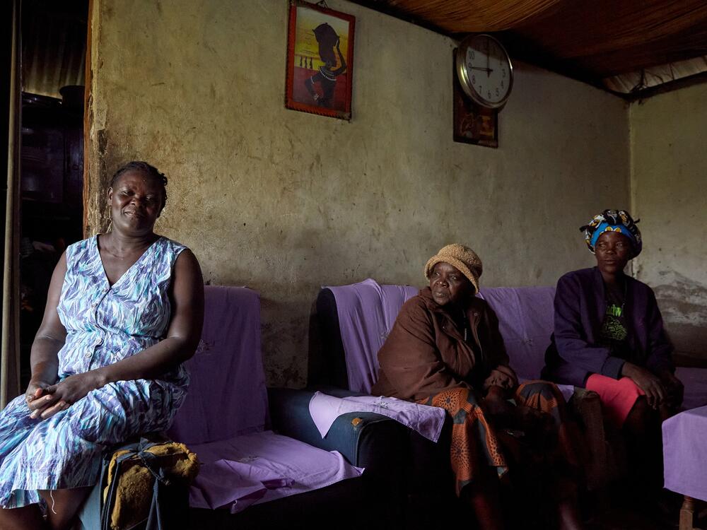 Rebbeccah Atieno (left) sits inside her current home, along with No Sex For Fish chairwoman Justine Adhiambo Obura and fellow member Naomy Akoth.
