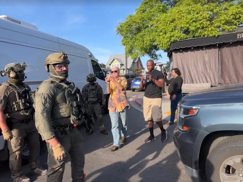 U.S. Immigration and Customs Enforcement agents execute a criminal search warrant on Friday, at the Buona Forchetta Italian restaurant in San Diego.