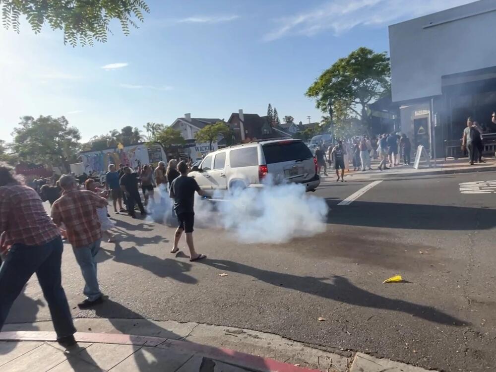 ICE agents used what appeared to be a smoke device to disperse the crowd near Buona Forchetta on Friday.