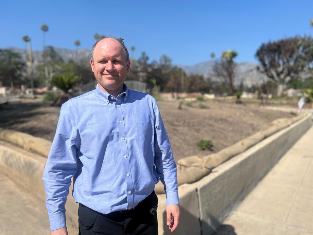 Andrew Whelton stands on a street in Altadena, CA where federal clean-up crews have recently cleared the way for rebuilding.