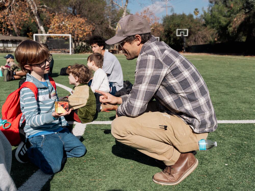 Project:Camp founder Mikey Latner talks to a camper.