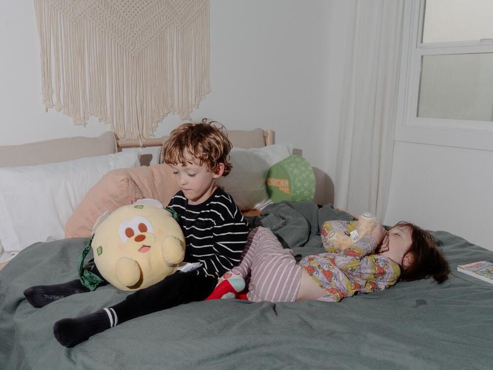 Eugene and Zella Eakin play with stuffed animals in their temporary home in El Sereno, Calif.