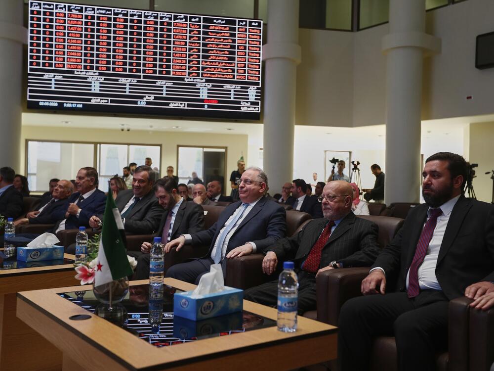 Syrian Finance Minister Mohammed Yisr Barnieh, center, attends the opening ceremony at the Damascus Securities Exchange in Damascus, Syria, Monday, June 2, 2025. (AP Photo/Omar Sanadiki)