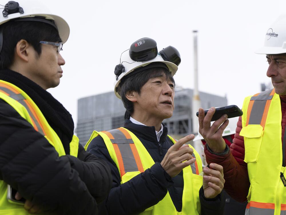 Matsuo Takehiko, center, Japan's Vice Minister for International Affairs at the Ministry of Economy, Trade and Industry, speaks to members of the media before a news conference at the Pump Station 1 on Monday, June 2, 2025, located near Deadhorse, Alaska, on the state's prodigious North Slope.