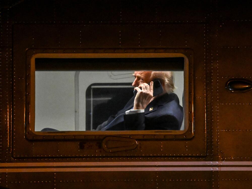 President Trump uses a cell phone aboard his Marine One helicopter in Leesburg, Va., on April 24, 2025.