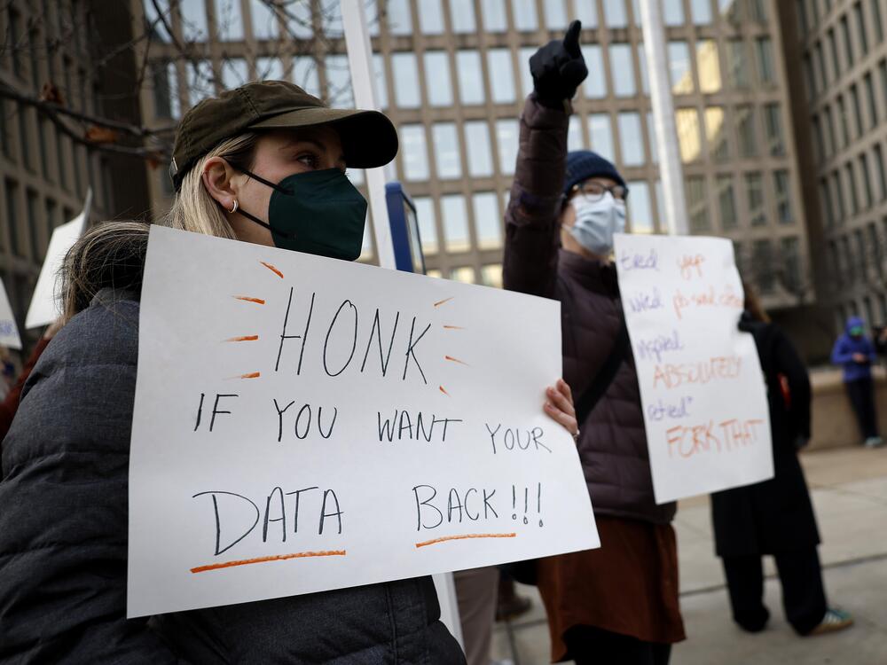 A protester with a sign saying 