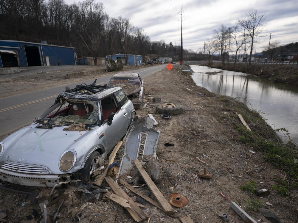 An abandoned vehicle sits along the Swannanoa River in a landscape scarred by Hurricane Helene, on March 24, near Swannanoa, N.C.