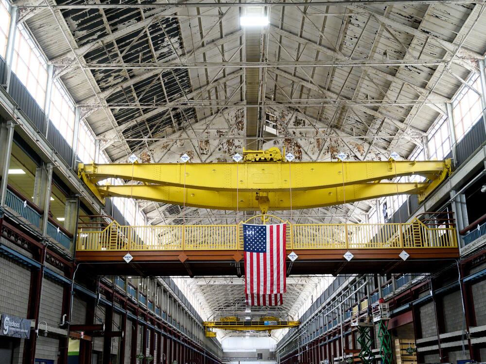 An American flag hangs inside the former Westinghouse plant in Turtle Creek, Pa., which now houses several businesses, including the Eos Energy Enterprises Inc. manufacturing facility.